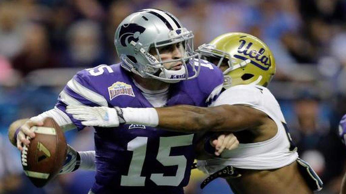 
Kansas State’s Jake Waters (15) is hit by UCLA's Deon Hollins as he tries to pass during the first half of the Alamo Bowl on Friday in San Antonio.
