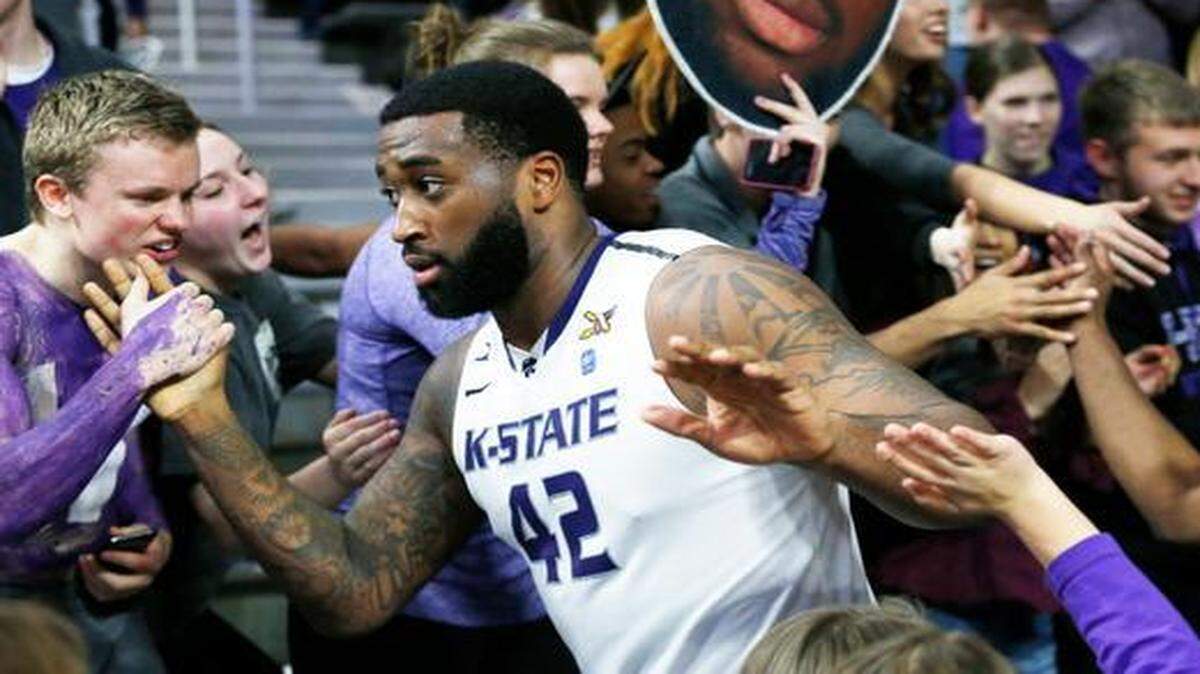 
K-State forward Thomas Gipson makes his way around Bramlage Coliseum to celebrate with fans after K-State upset #12 Iowa State 70-69. (February 28, 2015)
