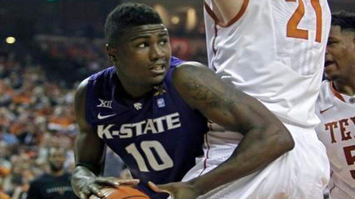
Kansas State forward Malek Harris (10) looked to pass around Texas forward Connor Lammert (21) in the first half Saturday in Austin, Texas.
