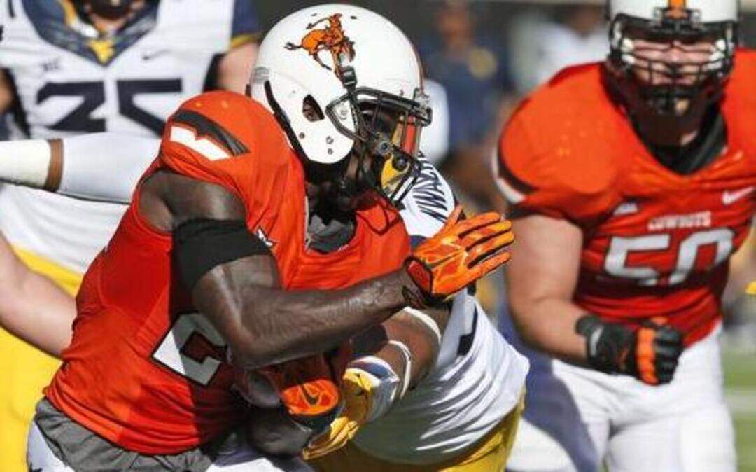 
Oklahoma State wide receiver Tyreek Hill is tackled by West Virginia defensive lineman Noble Nwachukwu. (AP Photo/Sue Ogrocki)
