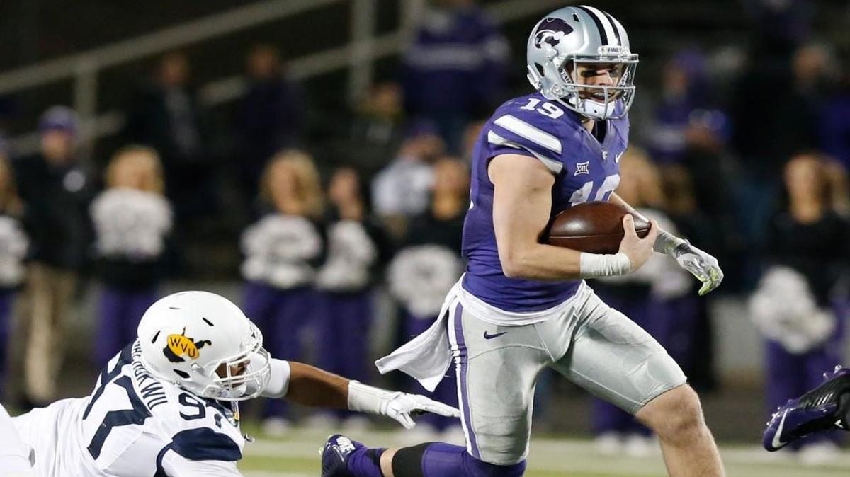 Kody Cook slips past West Virginia defensive lineman Noble Nwachukwu on Dec. 5. Inserted into the game at QB, Cook played well and may be in the mix to start the Liberty Bowl under center.