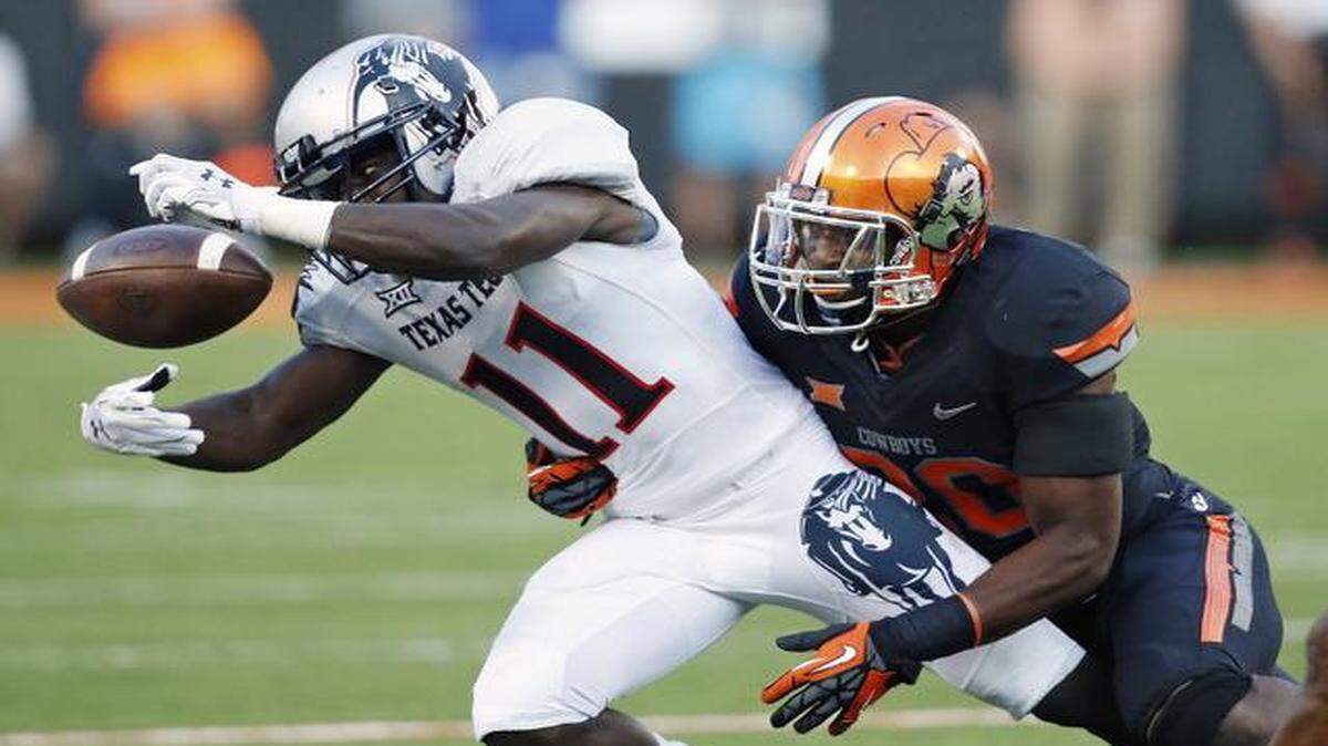 
Texas Tech wide receiver Jakeem Grant tries to get his hands on a pass against Oklahoma State. (AP Photo/Sue Ogrocki)

