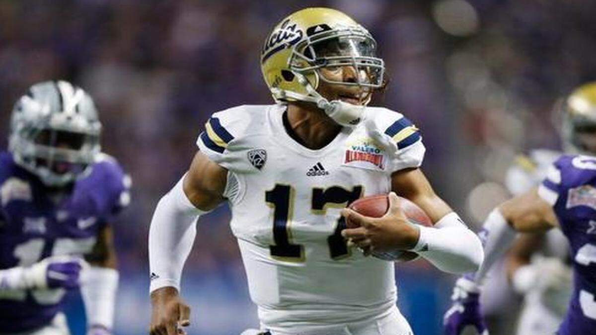 
UCLA quarterback Brett Hundley ran away from K-State defenders for his second touchdown of the game.
