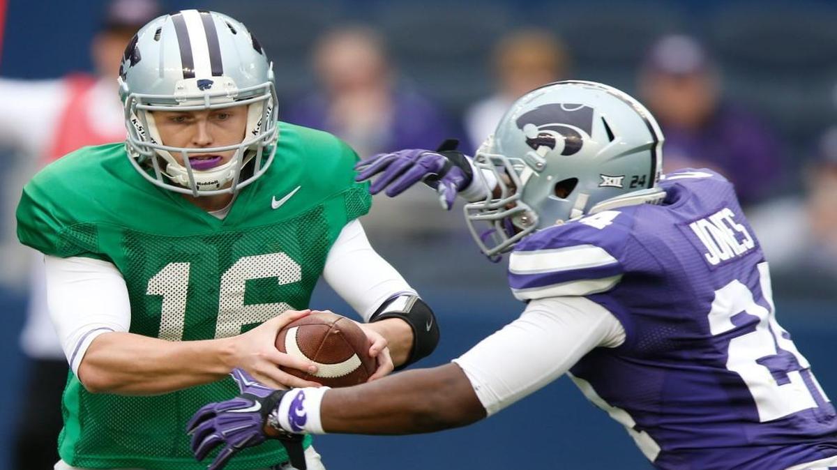 Quarterback Jesse Ertz hands off to running back Charles Jones in last April’s spring game.