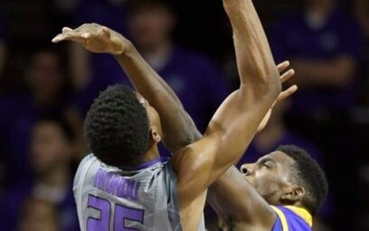
Kansas State forward Wesley Iwundu (left) was fouled by UMKC center Thaddeus Smith on Monday in an 83-73 win for the Wildcats in Manhattan, Kan.
