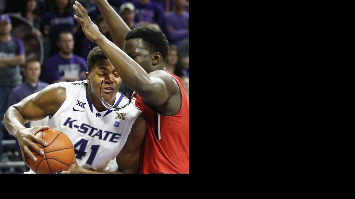 
K-State forward Stephen Hurt (41) loses his glasses after coliding with Texas Tech forward Norense Odiase (32) under the basket Wednesday night during second half action in Manhattan. K-State hung on to win 58-51.
