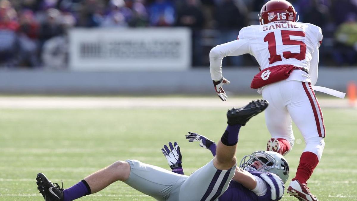 
Oklahoma defensive back Zack Sanchez intercepts a Jake Waters pass and leaves intended receiver K-State wide receiver Curry Sexton in his wake as he runs for a touchdown during the Sooners’ November 2013 victory in Manhattan.
