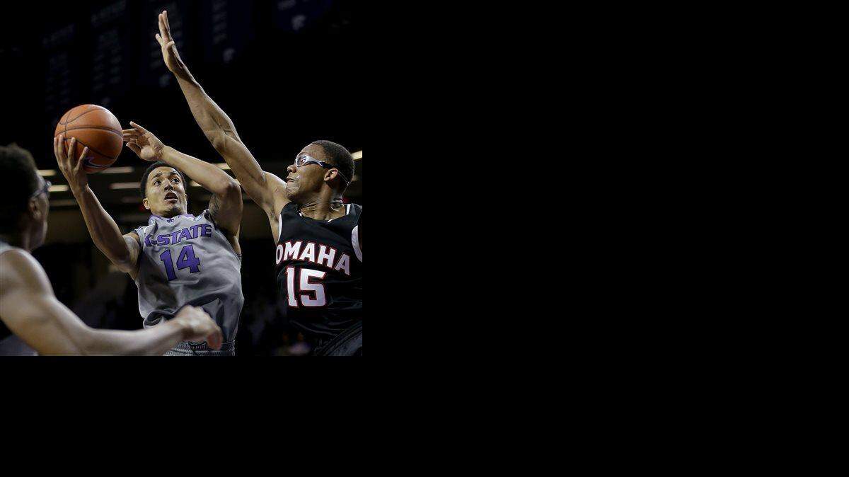 
Kansas State's Justin Edwards (14) shoots under pressure from Nebraska-Omaha's Tre'Shawn Thurman (15) during the first half of an NCAA college basketball game Tuesday, Dec. 2, 2014 in Manhattan, Kan. AP Photo/Charlie Riedel)
