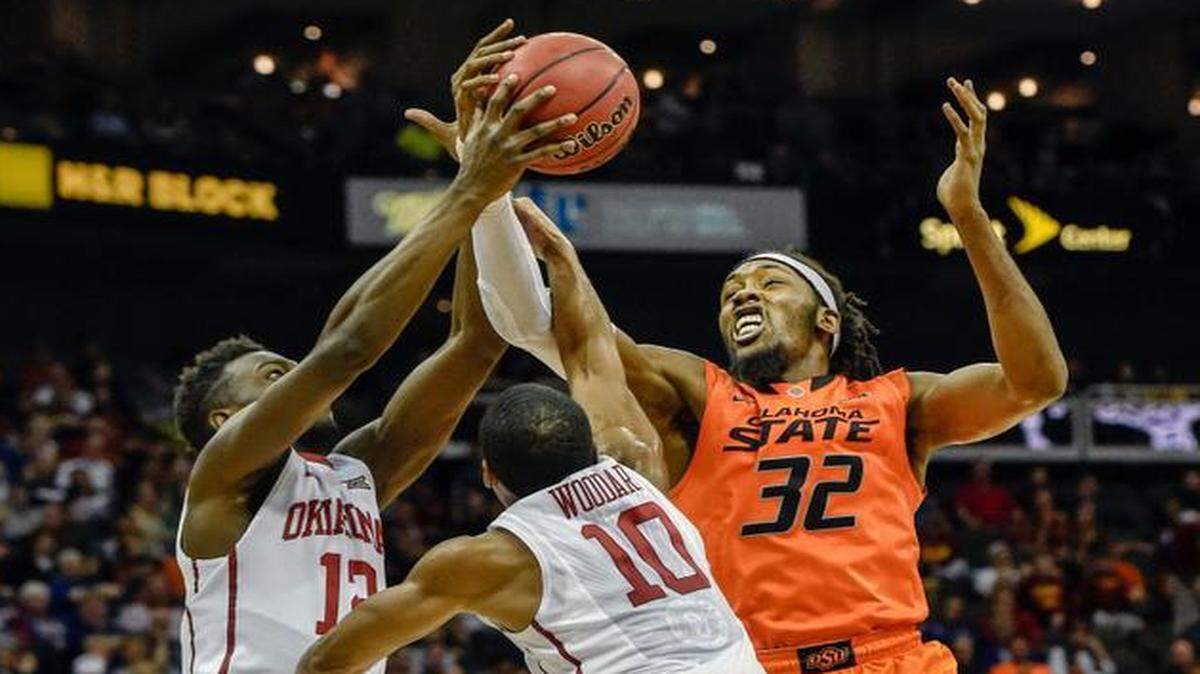Oklahoma State Cowboys forward/center Anthony Allen Jr. (32) fights for control of the ball with Oklahoma Sooners guard Khadeem Lattin (12) and Oklahoma Sooners guard Jordan Woodard (10) on Thursday, March 12, 2015, at the Sprint Center in Kansas City during the quarterfinal game of the Big 12 men's basketball tournament. The semifinals games continue on Friday, March 13, 2015.
