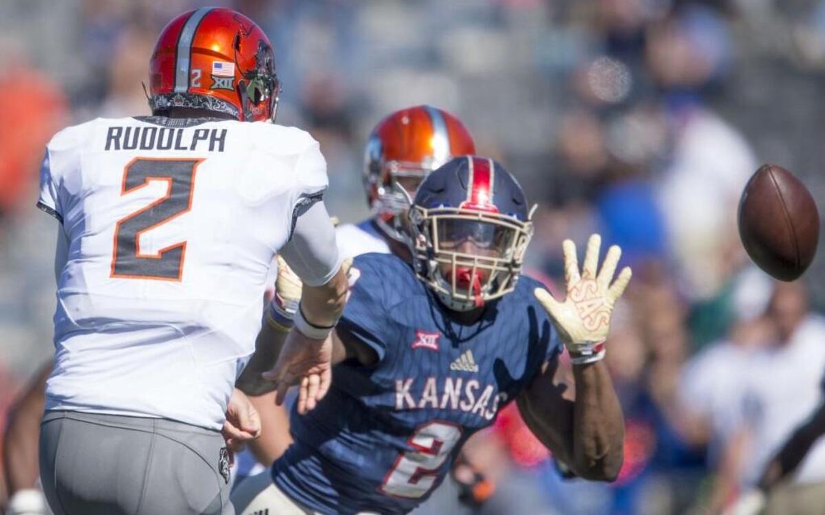 Oklahoma State quarterback Mason Rudolph got rid of the ball under pressure from Kansas defensive end Dorance Armstrong Jr. at Memorial Stadium in Lawrence, Kan., last season.