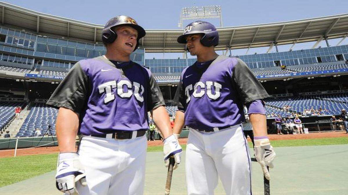 
TCU catcher Kyle Bacak (left) and TCU outfielder Boomer White surveyed the field during team practice Friday ahead of the NCAA College World Series at TD Ameritrade Park in Omaha, Neb. TCU plays Texas Tech on Sunday.
