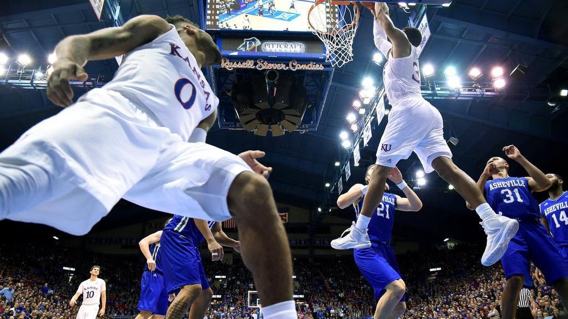 KU's Landen Lucas took a pass from teammate Frank Mason (0) a slammed home a dunk during the second half of Friday night's game at Allen Fieldhouse. KU beat UNC-Asheville, 95-57.