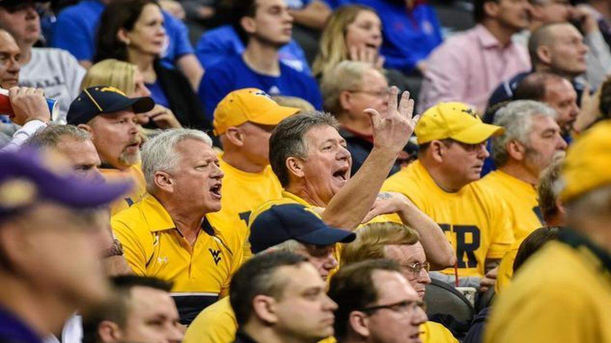 
A group of fans from West Virginia — including Mike McClung of Charleston (with hand raised) — saw their Mountaineers lose to Baylor on Thursday at the Sprint Center, but they’ll stick around for the rest of the Big 12 Tournament nonetheless.

