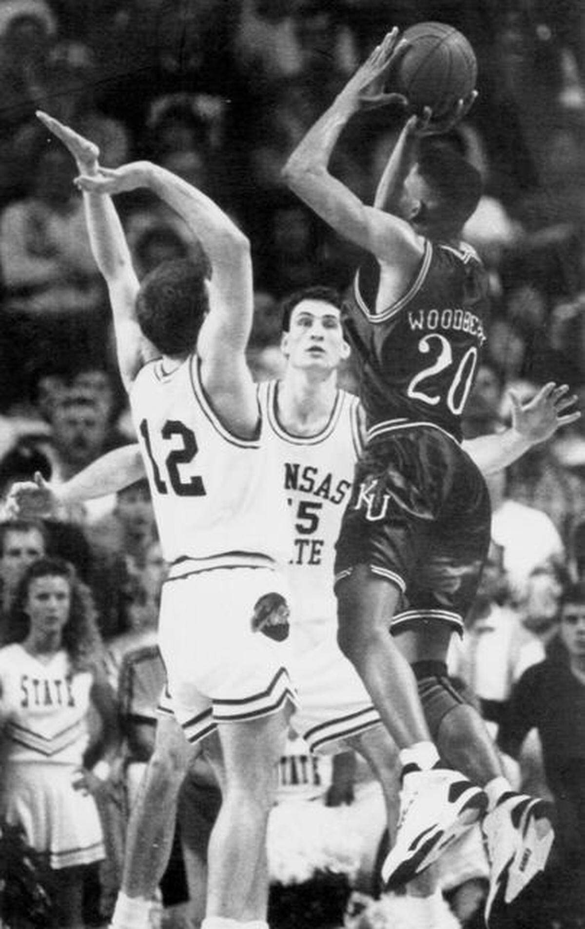 FILE: With the score 52-52 with seconds remaining, KU’s Steve Woodberry fires off a shot over the top of KSU’s Brian Henson, left, and John Rettiger, center, to win 54-52 as the buzzer sounded in 1992.
