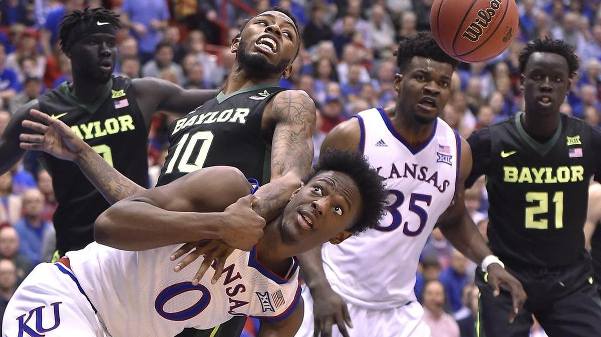 KU’s Marcus Garrett (0), who made only three of eight free throws in Saturday’s game, battled Baylor’s Tyson Jolly for a rebound in the second half at Allen Fieldhouse. Udoka Azubuike (35) made just four of 11 from the line as KU beat Baylor 70-67.