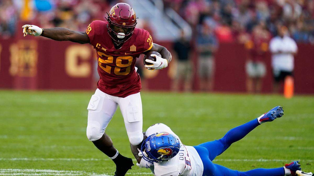 Iowa State running back Breece Hall (28) breaks a tackle by Kansas cornerback Ra’Mello Dotson, right, during the first half of a game, Saturday, Oct. 2, 2021, in Ames, Iowa.