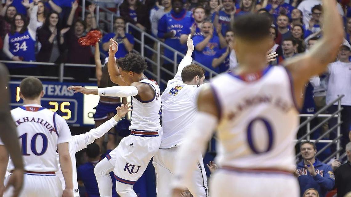 KU's Devonte' Graham (rear) celebrates with Tyler Self near the bench during the first half of a game against Texas at Allen Fieldhouse earlier this season.