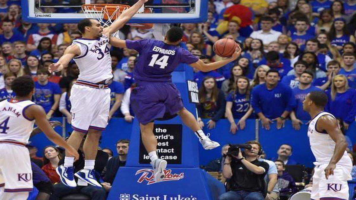 
Kansas’ Perry Ellis protects the rim as Kansas State’s Justin Edwards drives to the basket during the first half of Saturday's game at Allen Fieldhouse in Lawrence.
