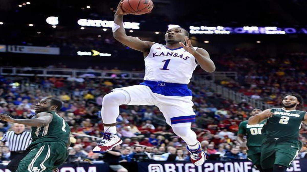 
KU's Wayne Selden flew past Baylor's Kenny Chery (left) and the trailing Rico Gathers (2) for two of his game-high 20 points during the second half of Friday's Big 12 Tournament semifinal game at the Sprint Center. KU beat Baylor 52-52 to advance to the championhsip game.
