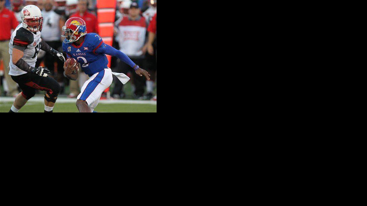 
Kansas quarterback Montell Cozart (right) looked for running room against Southeast Missouri State's Jon Slania in the second quarter of the Sept. 6 game in Lawrence.
