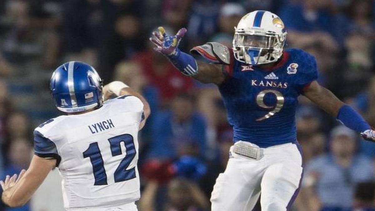 
Memphis quarterback Paxton Lynch threw a pass over Kansas safety Fish Smithson in the second quarter of Saturday’s game.
