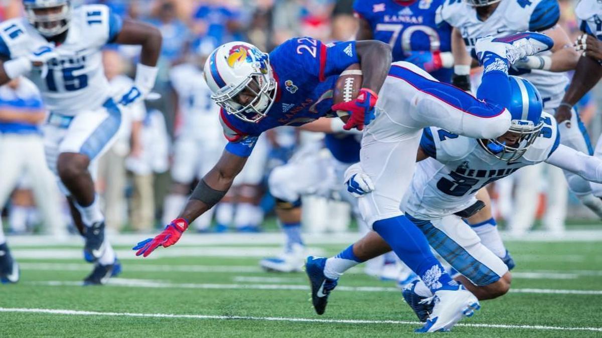 
Kansas Jayhawks running back Ke’aun Kinner kept his feet and gained more yards after Memphis Tigers defensive back DaShaughn Terry tried to tackle him in the first quarter of Saturday’s game.
