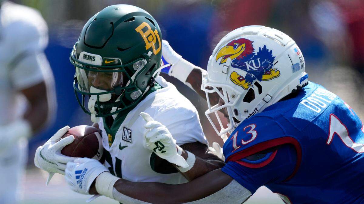 Baylor wide receiver Josh Fleeks (left) is tackled by Kansas cornerback Ra’Mello Dotson during the first half of the game in Lawrence, Kansas, Saturday, Sept. 18 2021.