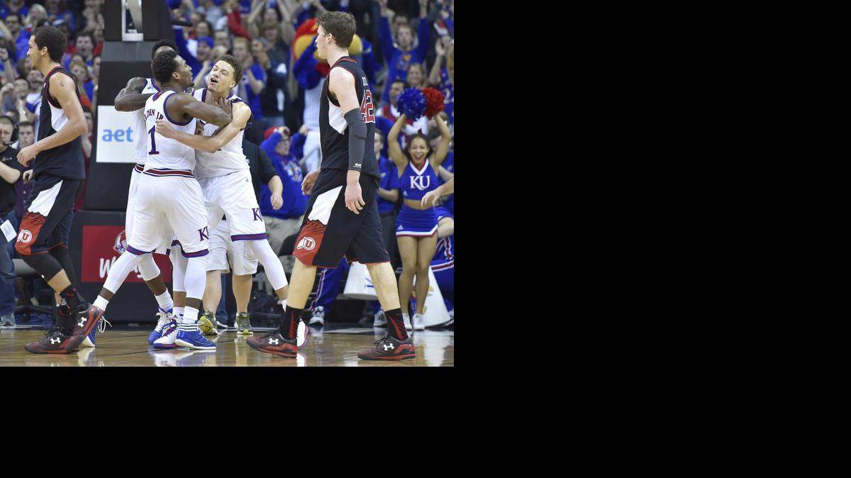 
KU's Wayne Selden Jr. gives teammate Brannen Grenne a congratulatory shove after the Jayhawks held on to beat Utah 63-60 Saturday at the Sprint Center.

