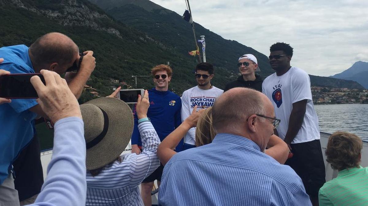 KU basketball fans take photos of Chris Teahan, Sam Cunliffe, Mitch Lightfoot and Udoka Azubuike on a boat tour of Lake Como on Monday morning. It was the Jayhawks’ final full day in Italy.