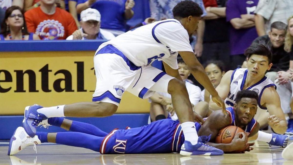 Kansas forward Jamari Traylor (bottom) gains control of a the ball as Chaminade's Rohndell Goodwin (left) and Kevin Hu defend Monday’s Maui Invitational college basketball game in Lahaina, Hawaii.