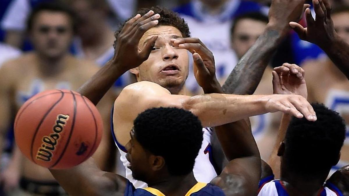 KU’s Brannen Greene (rear) knocks the ball away from Northern Colorado's Ibrahim Syla during the first half of Friday night’s game.