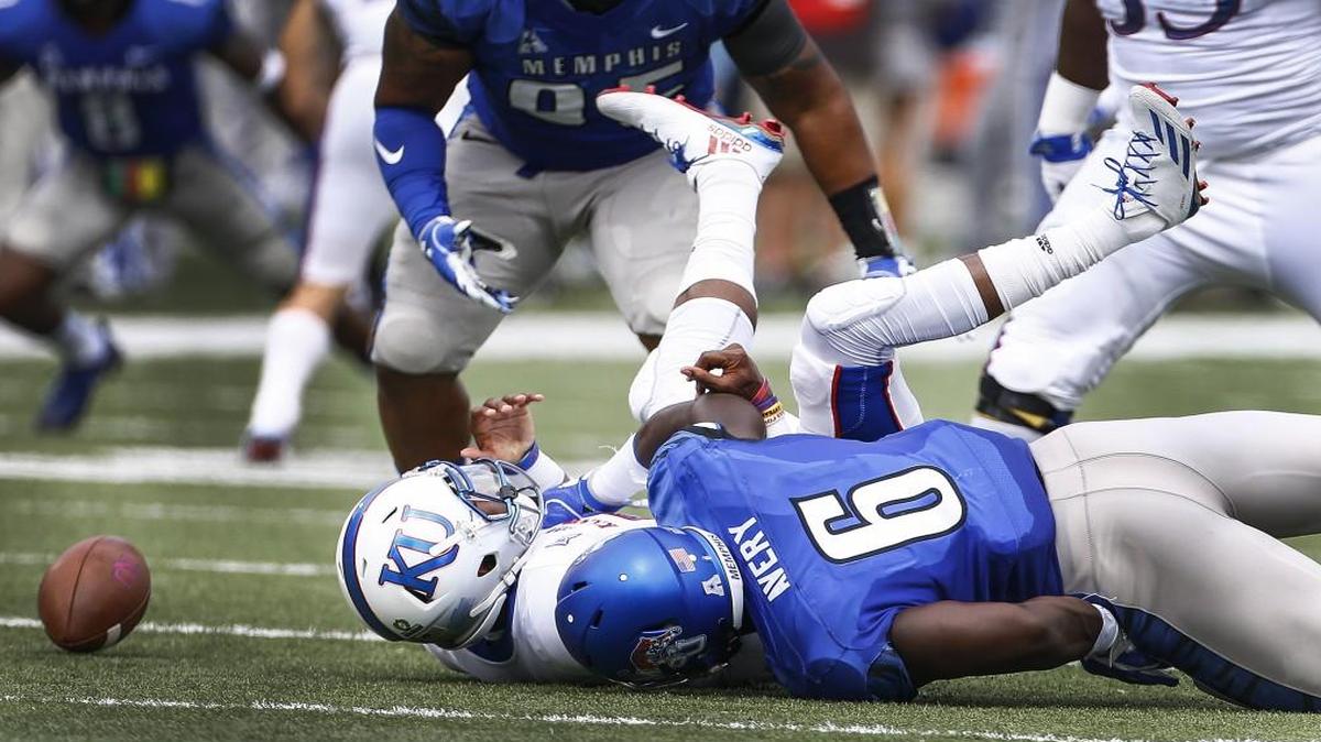Memphis defender Genard Avery knocked the ball away form Kansas quarterback Montell Cozart causing a fumble during last Saturday’s game.