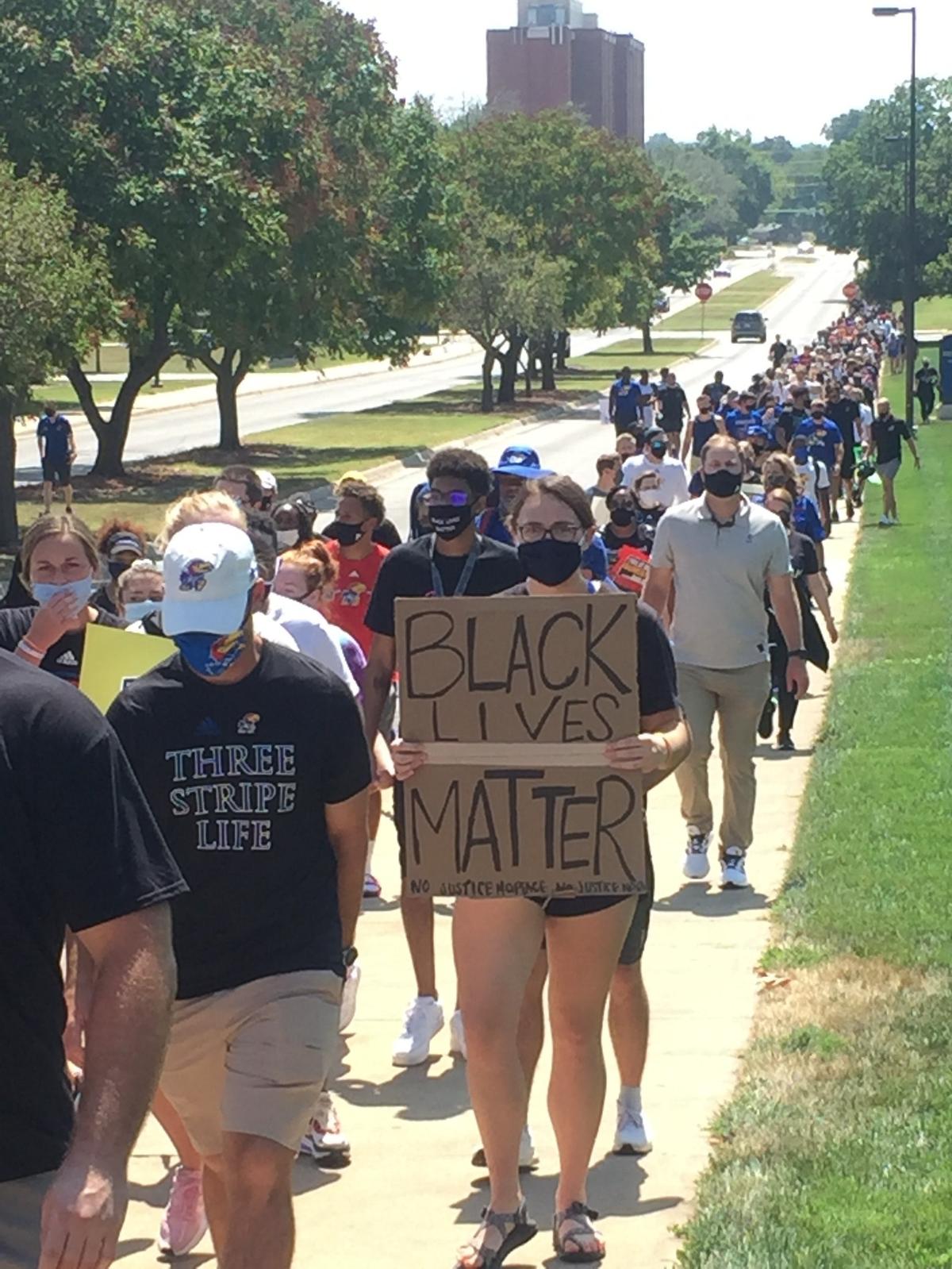 Kansas students and athletes line Naismith Drive while participating in a march supporting Black Lives Matter on Friday, Aug. 28, in Lawrence.