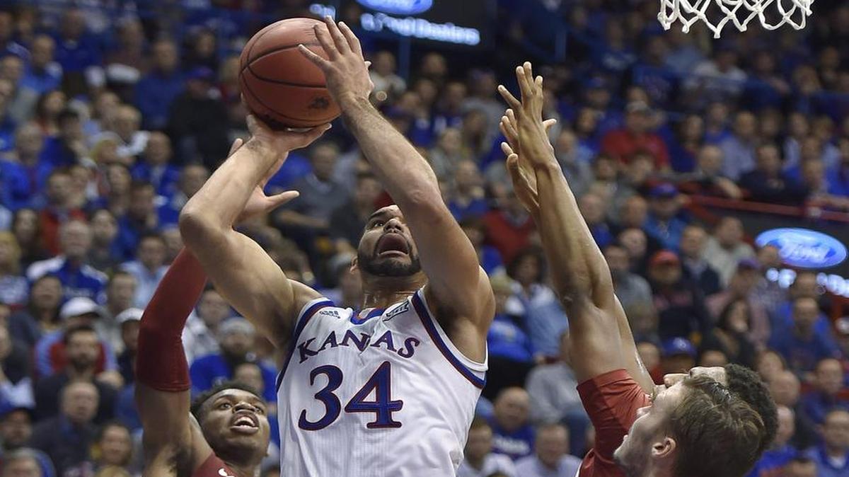 KU’s Perry Ellis scored a team-high 27 points Monday night, with these two coming over Oklahoma’s Buddy Hield (24) and Ryan Spangler (right).