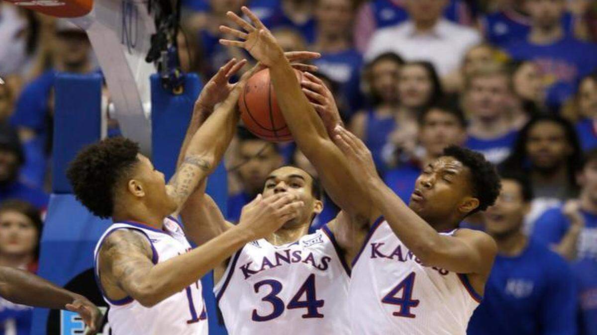 
Kansas guards Kelly Oubre Jr. (left), and Devonte Graham (right) along with forward Perry Ellis rebound during their Jan. 31 game against Kansas State in Allen Fieldhouse.
