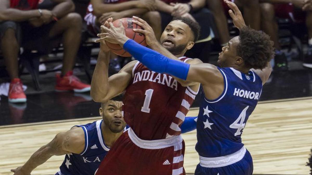 Indiana’s James Blackmon (center) attempted a layup between Kansas’ Frank Mason (left) and Devonte Graham in the second half of Friday night’s game in Honolulu.