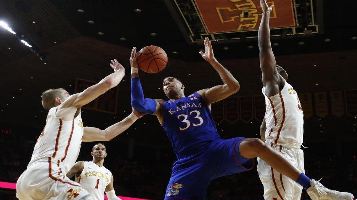 Kansas’s Landen Lucas grabbed a rebound between Iowa State’s Matt Thomas (left), Nick Weiler-Babb and Deonte Burton (right) in the first half of Monday’s game in Ames, Iowa.