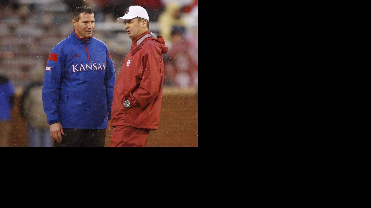 
Kansas interim coach Clint Bowen (left) and Oklahoma head coach Bob Stoops talked Saturday.

