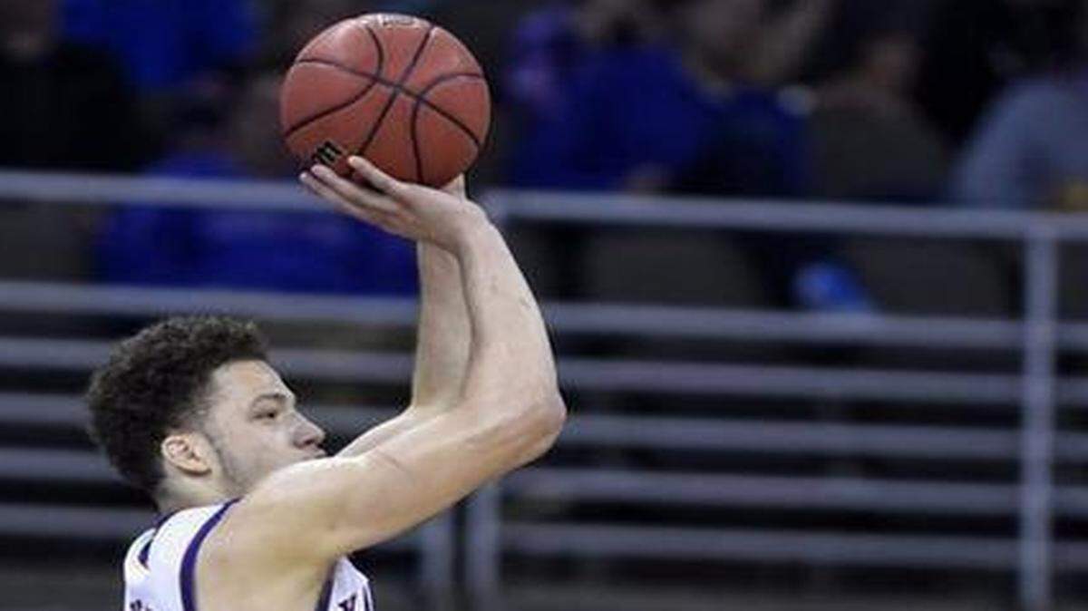 
KU’s Brannen Greene (left) found his shooting touch Friday, hitting two of four three pointers — including this one over New Mexico State’s Remi Barry in the second half.
