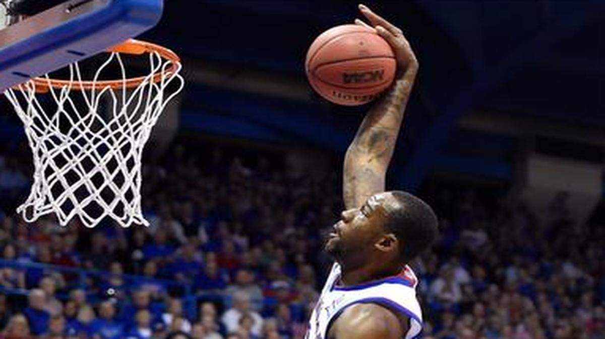 
KU’s Cliff Alexander may have mishandled the pass, but he still managed to slam home his second dunk in quick succession over Emporia State’s Jevon Taylor (21) in the second half of their exhibition game Tuesday night at Allen Fieldhouse. Kansas won 109-56.
