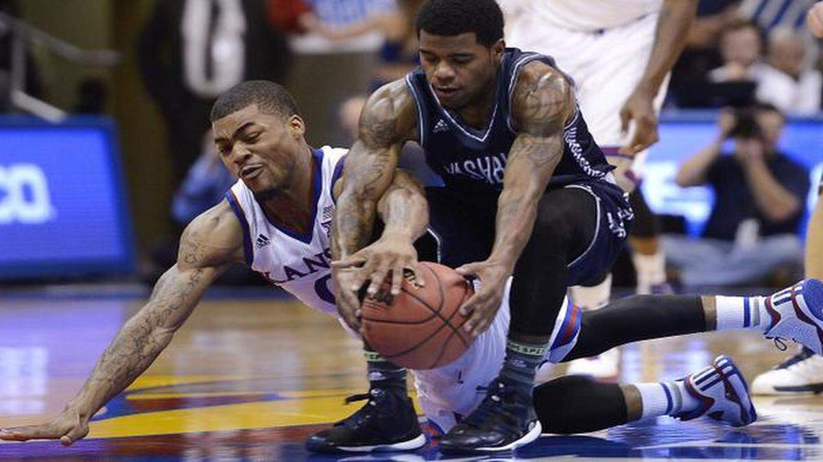 
KU’s Frank Mason (left) battled Washburn’s Kevin House for a loose ball during the second half of an exhibition game at Allen Fieldhouse.
