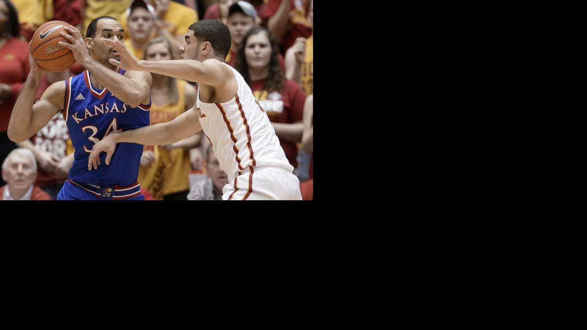 
Kansas forward Perry Ellis, left, looks to pass around Iowa State forward Georges Niang during the first half of an NCAA college basketball game, Saturday, Jan. 17, 2015, in Ames, Iowa. 
