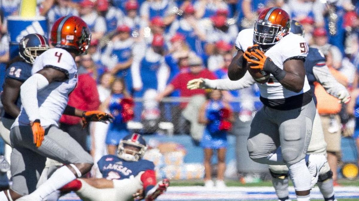 Oklahoma State Cowboys defensive tackle DeQuinton Osborne intercepted a pass thrown by Kansas Jayhawks quarterback Montell Cozart in the third quarter of Saturday’s game.
