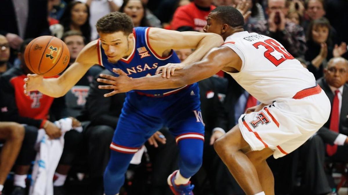 Kansas guard Brannen Greene (left) gets the ball knocked away by Texas Tech guard Toddrick Gotcher during Saturday’s Big 12 basketball game in Lubbock.