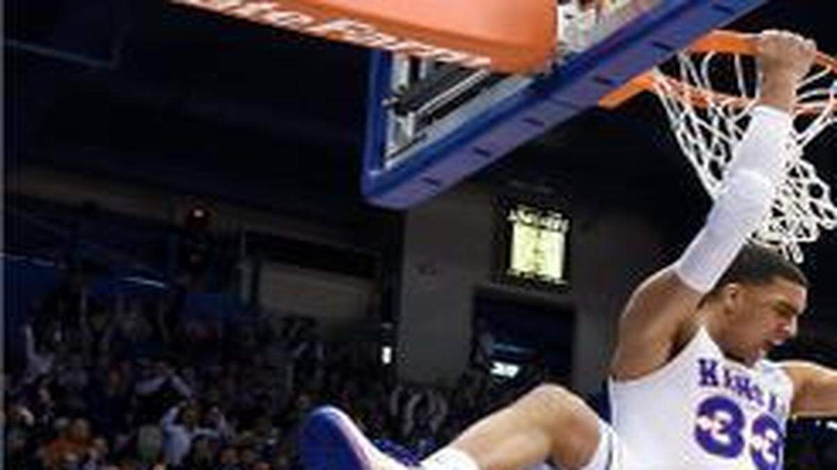 
KU’s Landen Lucas got Allen Fieldhouse rocking when he slammed home this alley-oop dunk over Texas’ Myles Turner (left) during the first half of Saturday’s game in Lawrence, Kan. KU rallied in the second half to win 69-64.
