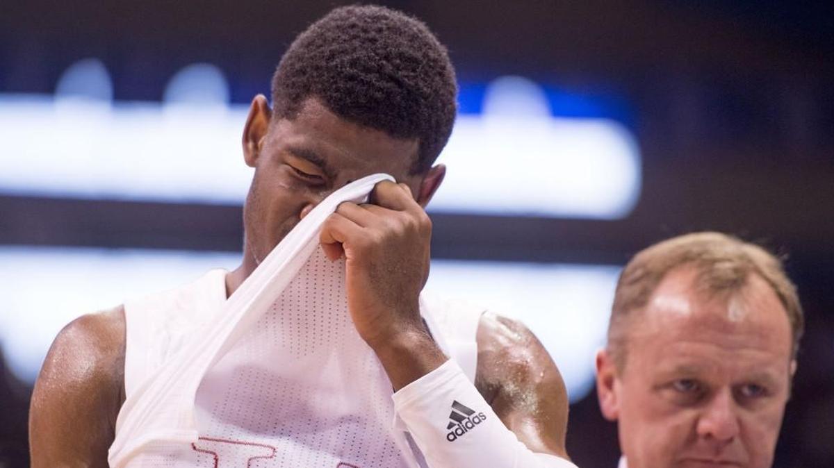 KU guard Malik Newman covered his face as he was escorted off the court during Sunday’s game at Allen Fieldhouse. He was diagnosed with a concussion after the Jayhawks’ loss to Arizona State.