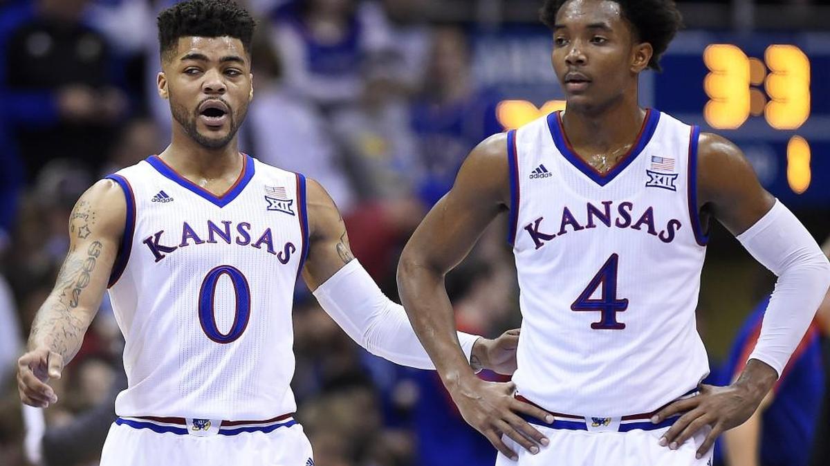 KU’s Frank Mason (0) and Devonte’ Graham talk strategy during a break in the action of the first half of Saturday’s game at Allen Fieldhouse. KU beat Texas 79-67.