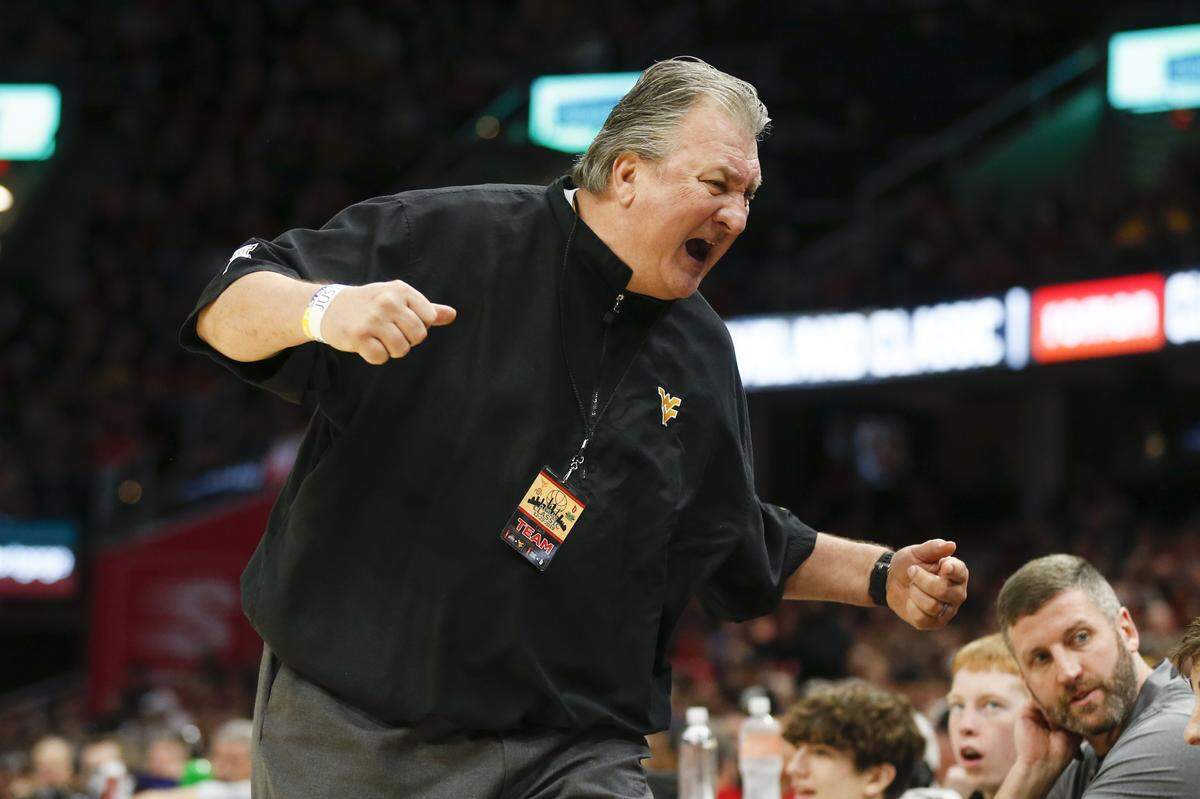 West Virginia head coach Bob Huggins reacts to a play against Ohio State during the second half of an NCAA college basketball game Sunday, Dec. 29, 2019, in Cleveland. West Virginia defeated Ohio State 67-59.