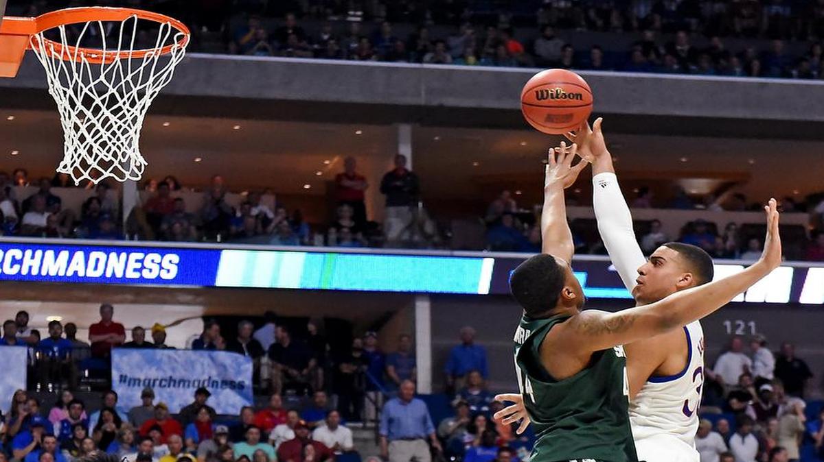 KU’s Landen Lucas went to his right hand to shoot over Michigan State’s Nick Ward in Sunday’s NCAA Tournament game in Tulsa, Okla.