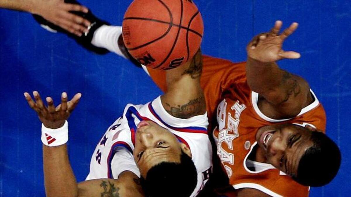 On March 3, 2007, Kansas won the Big 12 Conference title outright by beating Texas 90-86 in Lawrence. It was all KU and Brandon Rush, left, could do to subdue Justin Mason and Texas. Rush finished with 15 points, which helped give coach Bill Self and the Jayhawks a chance to cut down the nets.